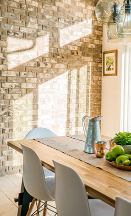 Dining table next to a brick wall